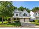 Charming two-story home featuring a two-car garage, inviting front porch, and lush landscaping at 301 Downing Creek Trl, Canton, GA 30114