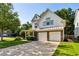 Beautiful home featuring a two-car garage and inviting front porch, set amidst lush landscaping at 301 Downing Creek Trl, Canton, GA 30114