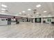 Spacious fitness center with hardwood floors, mirrored wall, fans, and various exercise equipment for a complete workout experience at 301 Downing Creek Trl, Canton, GA 30114