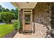Inviting front entrance with stone accents, decorative wreath, and manicured landscaping at 301 Downing Creek Trl, Canton, GA 30114