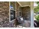 Charming front porch featuring stone accents, cozy wicker chair, and a Canton-themed pillow at 301 Downing Creek Trl, Canton, GA 30114