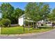 Well-maintained corner lot with lush lawn and mature trees framing a charming two-story home at 301 Downing Creek Trl, Canton, GA 30114