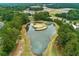 Aerial view of community golf course island green in a serene pond, framed by lush greenery and neighborhood views at 301 Downing Creek Trl, Canton, GA 30114