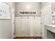 Farmhouse style hallway with board and batten accent wall and coat hooks at 301 Downing Creek Trl, Canton, GA 30114