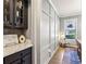 Hallway with modern wainscotting, a white console table, wood floors, and a gray wall at 301 Downing Creek Trl, Canton, GA 30114