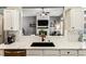 Kitchen view with quartz countertop and stainless steel appliances overlooking the living room with fireplace at 301 Downing Creek Trl, Canton, GA 30114