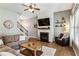 Inviting living room with wood floors, fireplace and staircase to second level at 301 Downing Creek Trl, Canton, GA 30114