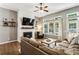 Cozy living room featuring a fireplace with TV, shiplap wall, and view to backyard at 301 Downing Creek Trl, Canton, GA 30114