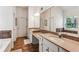 Bright main bathroom with double sinks, a large mirror, and tile flooring, blending functionality and style at 301 Downing Creek Trl, Canton, GA 30114