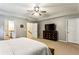 Spacious primary bedroom featuring neutral carpet, ceiling fan, dresser and doors to the en suite and walk-in closet at 301 Downing Creek Trl, Canton, GA 30114