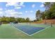 Outdoor pickleball courts, perfect for friendly matches and active community engagement amidst lush greenery and clear skies at 301 Downing Creek Trl, Canton, GA 30114