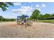 playground area filled with sand and featuring slides, swings, and climbing structures for outdoor fun at 301 Downing Creek Trl, Canton, GA 30114