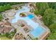 Aerial view of the neighborhood pool, including a splash pad, lap pool, lounge areas and seating surrounded by trees at 301 Downing Creek Trl, Canton, GA 30114