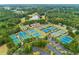 Aerial view of the BridgeMill community featuring several tennis courts and lush greenery at 301 Downing Creek Trl, Canton, GA 30114