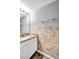 This bathroom has a marble vanity, tile backsplash, and black floors at 4000 Crossings Way, Stone Mountain, GA 30083