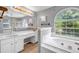Bright bathroom features soaking tub, separate shower stall, double vanity and arched window at 4000 Crossings Way, Stone Mountain, GA 30083