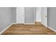The room showcases hardwood floors, white baseboards, and a white door at 4000 Crossings Way, Stone Mountain, GA 30083