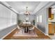 Elegant dining room with a chandelier, space for eight, and hardwood flooring at 4000 Crossings Way, Stone Mountain, GA 30083