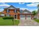 Charming two-story brick home with a well-manicured lawn and attached two car garage at 4000 Crossings Way, Stone Mountain, GA 30083