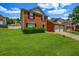 Charming two-story brick home with lush green lawn and a driveway to a 2-car garage at 4000 Crossings Way, Stone Mountain, GA 30083