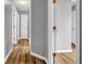 The hallway features hardwood floors, neutral paint, and white doors at 4000 Crossings Way, Stone Mountain, GA 30083