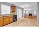 Kitchen featuring wood cabinets, granite counters, and an open view into the living room at 4000 Crossings Way, Stone Mountain, GA 30083