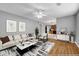Comfortable living room with a fan, hardwood flooring, and neutral color scheme at 4000 Crossings Way, Stone Mountain, GA 30083