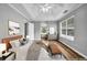 Spacious main bedroom with a ceiling fan, tray ceiling, and natural light at 4000 Crossings Way, Stone Mountain, GA 30083