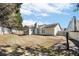A sprawling backyard shows a well-kept lawn, white fences, and a house with neutral siding and a screened-in porch at 4124 Berwick Farm Dr, Duluth, GA 30096