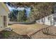Large fenced backyard with trees and some green grass growing provides space for outdoor activities at 4124 Berwick Farm Dr, Duluth, GA 30096