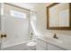 Bathroom featuring tiled walls around the bathtub, a window and a vanity at 4124 Berwick Farm Dr, Duluth, GA 30096