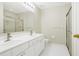 Bright bathroom with double sink vanity, large mirror, and glass enclosed shower at 4124 Berwick Farm Dr, Duluth, GA 30096