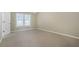 Empty bedroom featuring neutral walls, carpet, and a large window at 4124 Berwick Farm Dr, Duluth, GA 30096