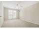 This bedroom features carpet, neutral walls, a ceiling fan and a window at 4124 Berwick Farm Dr, Duluth, GA 30096