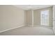 Cozy bedroom featuring carpet, neutral walls, and a window offering natural light at 4124 Berwick Farm Dr, Duluth, GA 30096