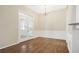 Dining area with hardwood floors, decorative lighting, and a seamless flow to the kitchen at 4124 Berwick Farm Dr, Duluth, GA 30096