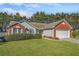 Charming single-Gathering home with a brick and siding exterior, manicured lawn, and an attached two-car garage at 4124 Berwick Farm Dr, Duluth, GA 30096