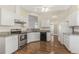 Modern kitchen with stainless steel appliances, granite countertops, and bright white cabinetry at 4124 Berwick Farm Dr, Duluth, GA 30096