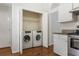 Convenient laundry closet with stainless steel appliances, and counter space at 4124 Berwick Farm Dr, Duluth, GA 30096
