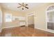 Living room with hardwood floors, a ceiling fan, built in cabinets, and large windows at 4124 Berwick Farm Dr, Duluth, GA 30096