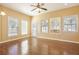 Bright living room featuring hardwood floors, neutral walls, large windows, and a ceiling fan at 4124 Berwick Farm Dr, Duluth, GA 30096
