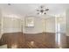 Expansive living room with hardwood floors, decorative lighting, and seamless flow to other spaces at 4124 Berwick Farm Dr, Duluth, GA 30096