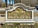 Decorative stone sign with gold lettering indicates the entrance to Chattahoochee Landing at 4124 Berwick Farm Dr, Duluth, GA 30096