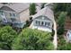Aerial view shows a traditional home with a well-manicured lawn, and mature trees around the property at 647 East Ne Ave, Atlanta, GA 30312