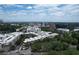 Aerial view shows a cityscape with modern buildings surrounded by lush green trees and a cloudy blue sky at 647 East Ne Ave, Atlanta, GA 30312