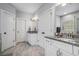 Granite vanity with dual sinks, tile floors, and white cabinetry in this bright bathroom at 647 East Ne Ave, Atlanta, GA 30312