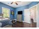 This blue bedroom features hardwood floors, blue walls and a door that leads to a light pink room at 647 East Ne Ave, Atlanta, GA 30312