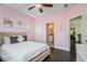 Light and airy pink bedroom with hardwood floors and stylish decor at 647 East Ne Ave, Atlanta, GA 30312