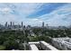 Expansive city skyline view from this property, surrounded by mature trees and greenery at 647 East Ne Ave, Atlanta, GA 30312
