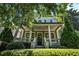 Charming two-story home boasting a covered front porch with lush landscaping, creating a welcoming curb appeal at 647 East Ne Ave, Atlanta, GA 30312